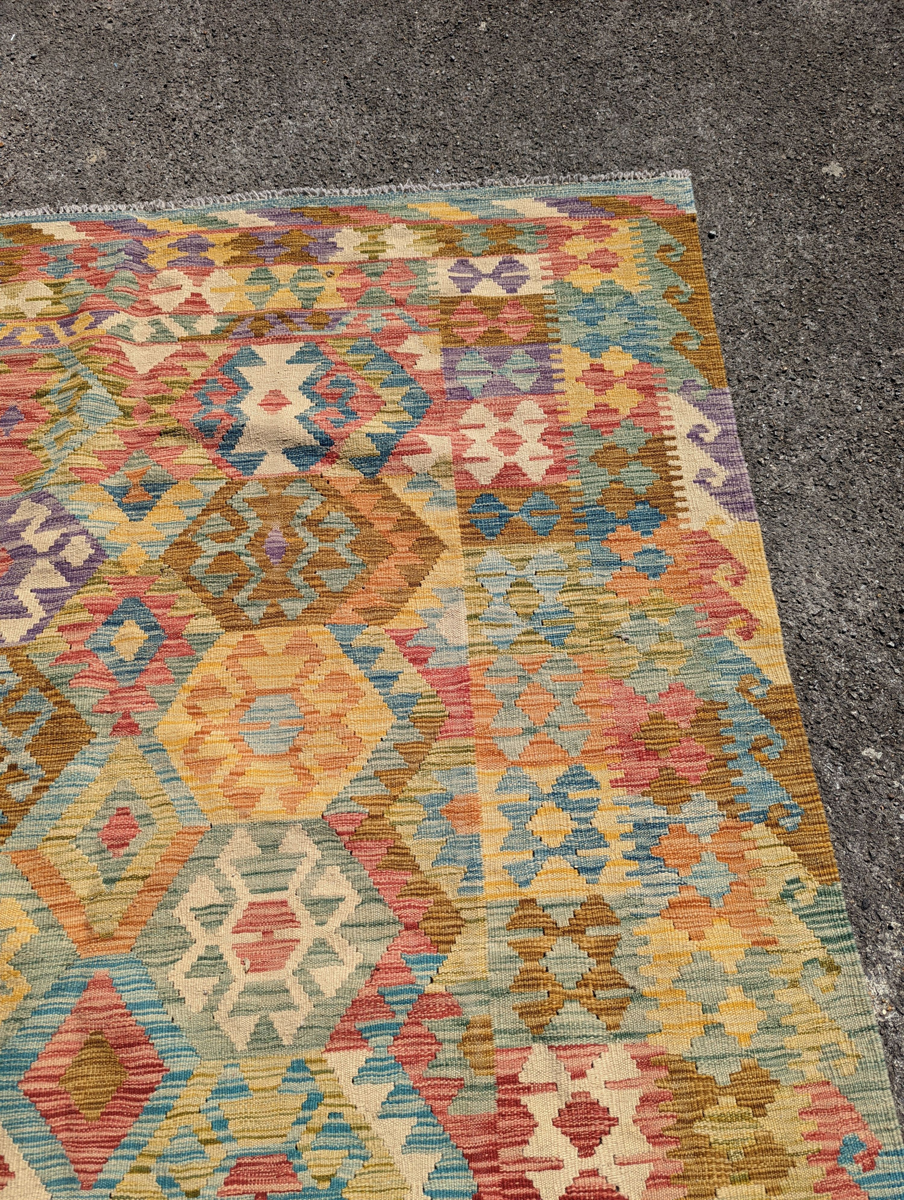 An Anatolian design polychrome geometric flatweave Kilim carpet 270 x 200cm